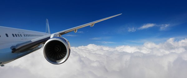 Jet engine on plane in clouds.