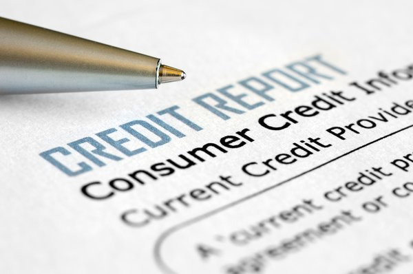 A close-up of a credit report and pen.