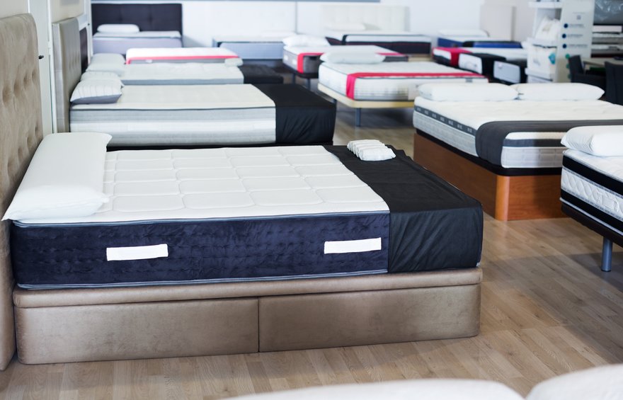 Mattresses on display inside a store.
