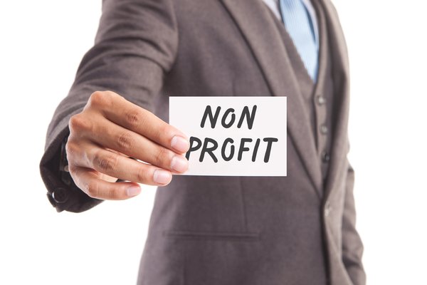 A man holds up a sign that says nonprofit